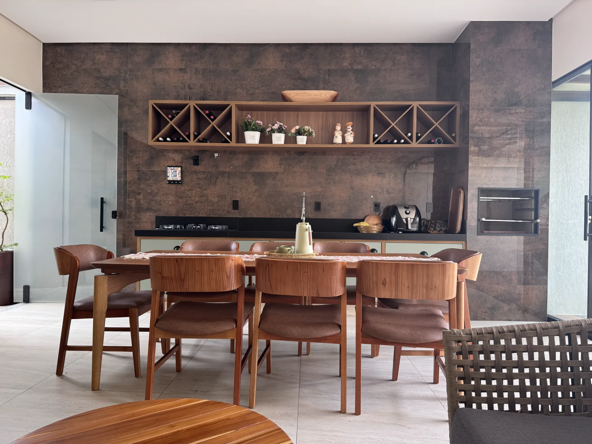 Área gourmet com marcenaria, adega e mesa de jantar